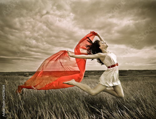 Plakat na zamówienie Brunette girl with red fabric in summer day