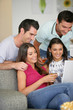 © auremar - Two couples at home laughing at a laptop