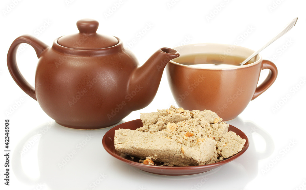 Teapot with cup and saucer with  sweet halva isolated on white