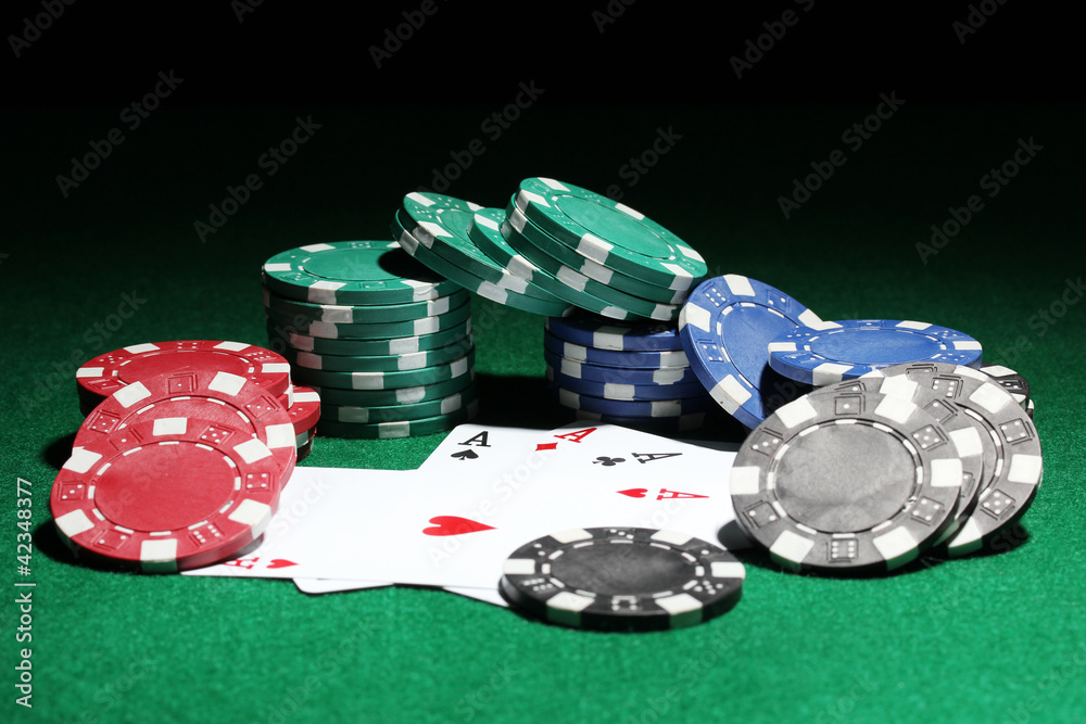 Cards and chips for poker on green table