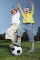 Wall Mural - two happy boy play in soccer