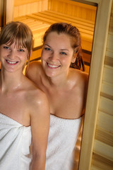 Wall Mural - Two women at sauna wrapped in towel