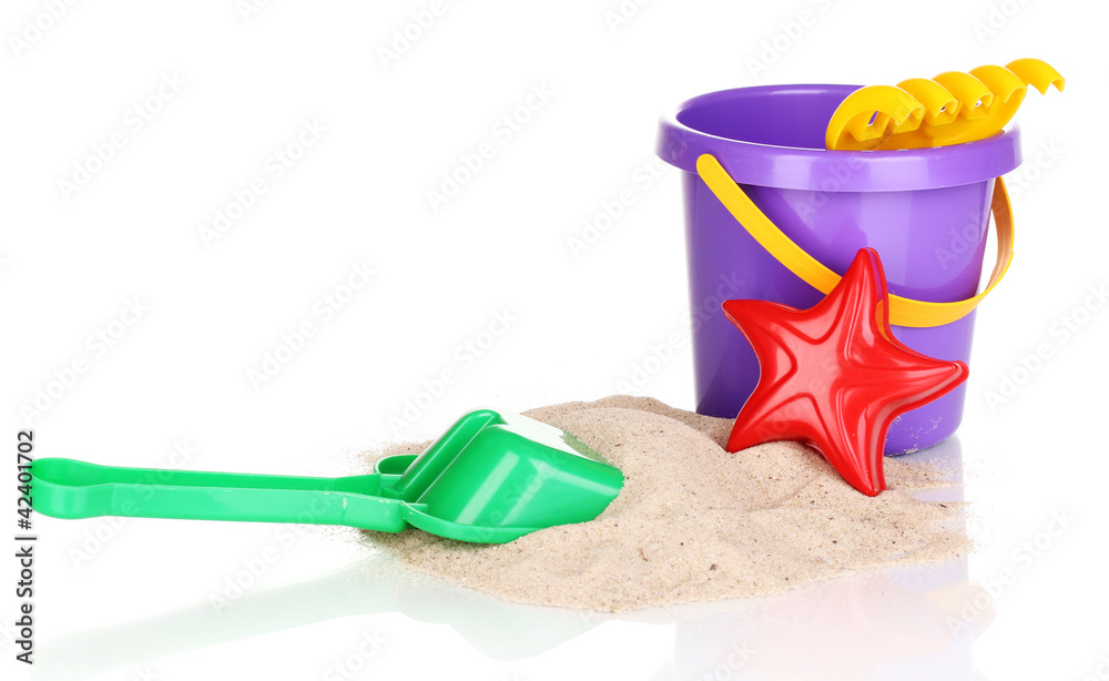 Children's beach toys and sand isolated on white