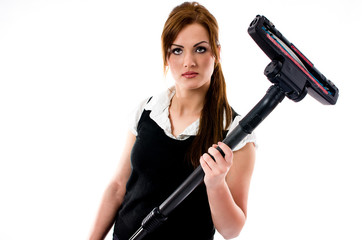 Wall Mural - Beautiful brunette woman holding a vacuum cleaner