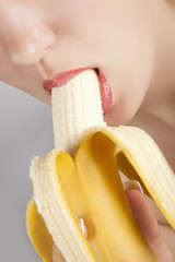 young woman eating banana