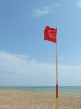 Red Warning Flag At Beach