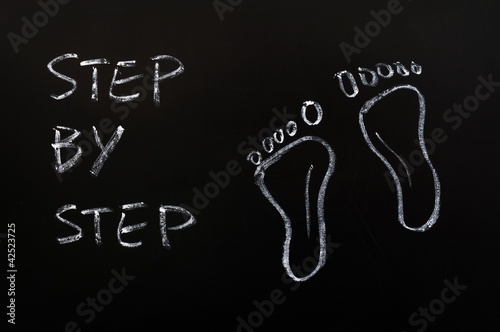 Fotografie, Obraz Footprints and the words step by step drawn with chalk