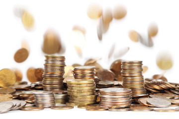 stacks of silver and golden coins and falling coins on backgroun