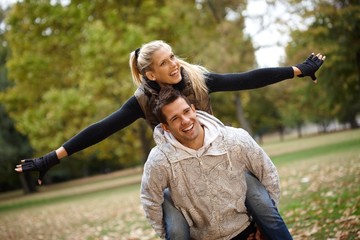 Sticker - Young couple having fun in autumn park