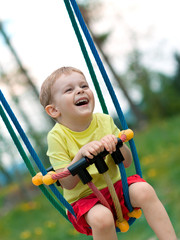 Baby boy playing on swing