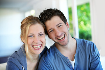 Closeup of cheerful young couple wearing blue