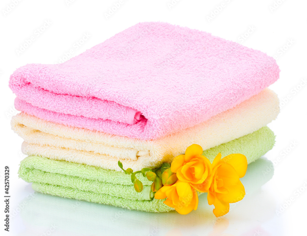 colorful towels and flowers isolated on white