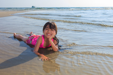 little girl laying in water