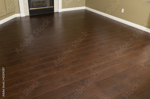 Fotografie, Obraz Newly Installed Brown Laminate Flooring and Baseboards in Home