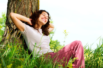 Wall Mural - beautiful young woman relaxing outdoors. nature