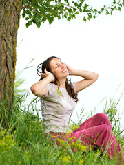 Wall Mural - beautiful young woman with headphones outdoors. enjoy music