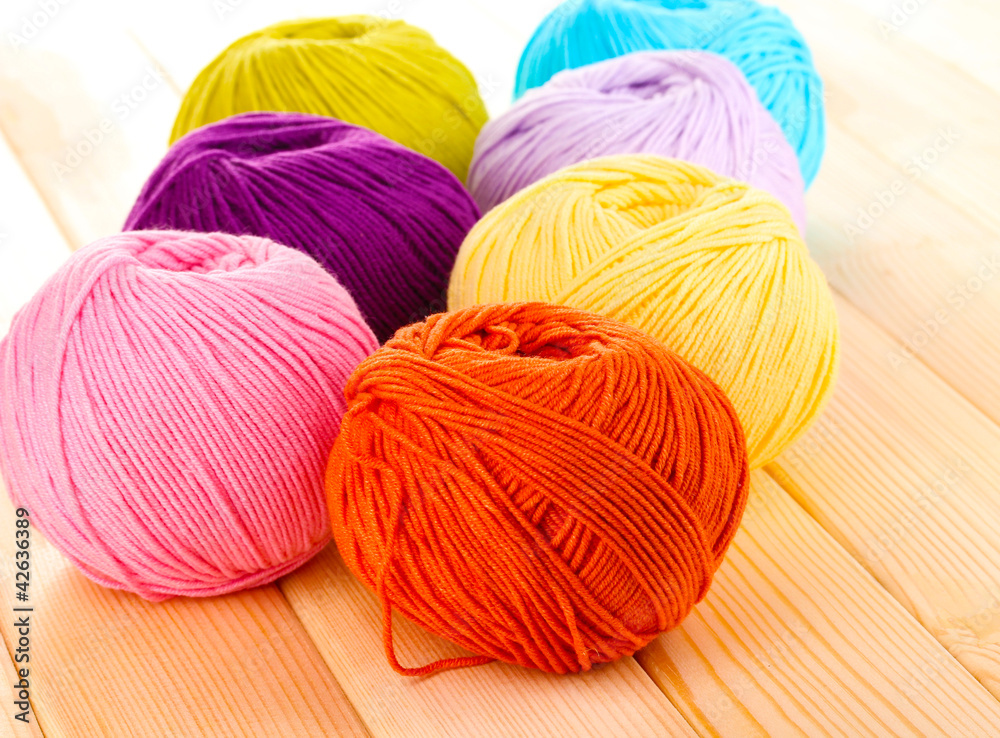 Knitting yarn on wooden background
