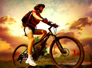 Wall Mural - Happy Young Woman riding bicycle outside. Healthy Lifestyle