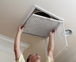 © steheap - Senior man opening air conditioning filter in ceiling
