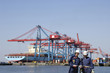 large container port with dock workers in foreground