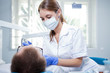 © Sergey Mironov - A young female dentist working in her office.