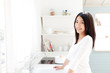 © taka - a young asian woman in the kitchen