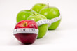 Red and green apples with measuring tape