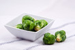 Fresh Brussels Sprouts in white bowl