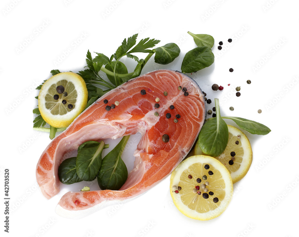 Red fish with lemon, parsley and pepper isolated on white.