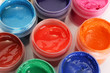 © Africa Studio - jars with multicolored gouache on white background close-up