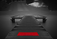Moody Empty Jetty With Red Mat Against Stormy Clouds
