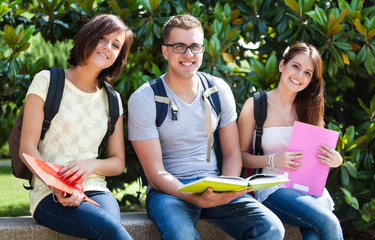 group of smiling students sitting on a bench