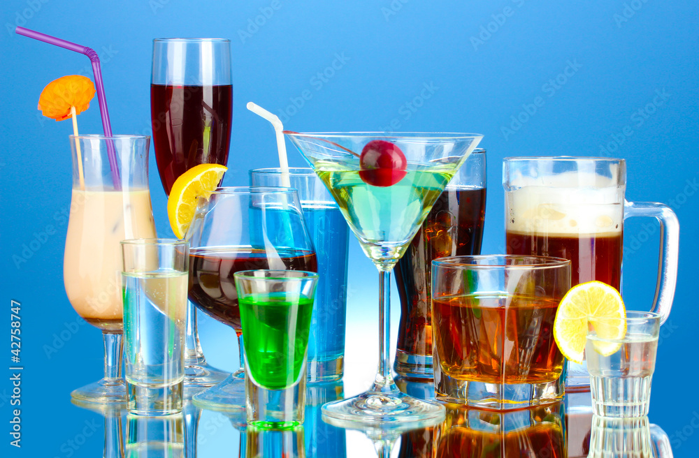 a variety of alcoholic drinks on blue background