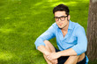 © matusciac - handsome man standing on the grass