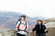 © blas - Couple hiking in mountains, man and woman trekking