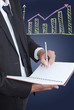 © ohmega1982 - Businessman write on notebook with graph.
