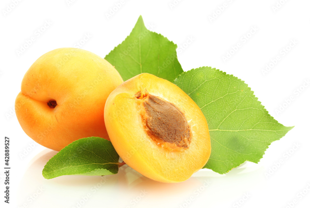 ripe sweet apricots with green leaves isolated on white