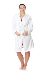 Beautiful woman standing wearing bathrobe.