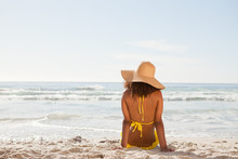 Young Attractive Woman Looking At The Ocean While Sunbathing