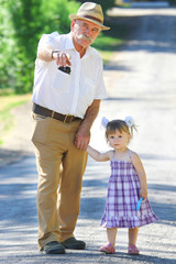 grandfather and granddaughter are on the road