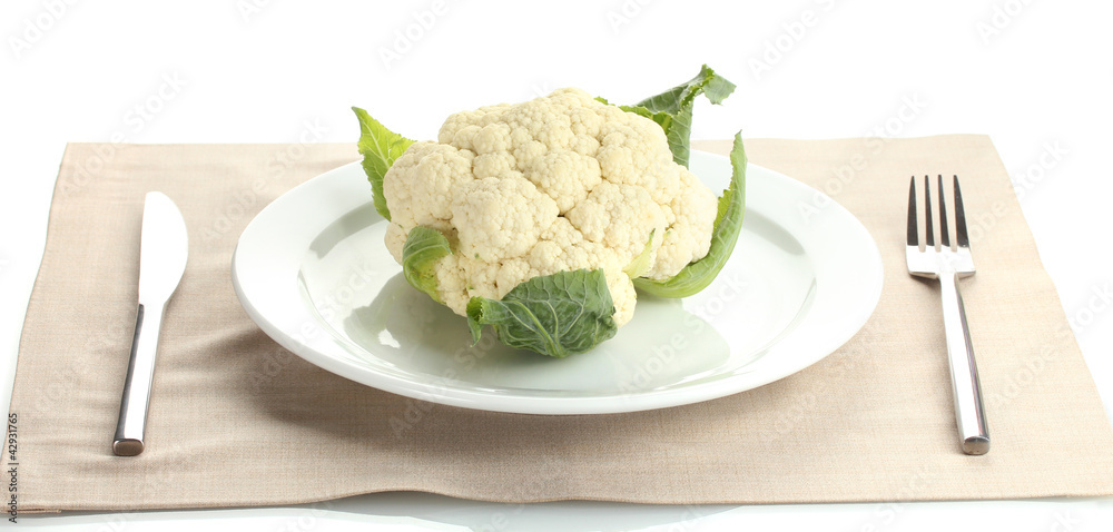 Fresh cauliflower on plate, knife and fork isolated on white