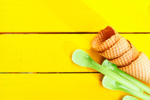 Ice Cream Cones And Green Plastic Spoons