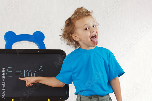 Little boy shows tongue like Einstein near formula Poster