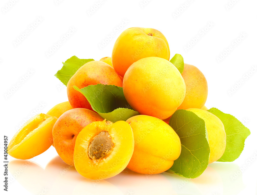 ripe apricots with green leaves isolated on white
