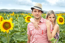Happy Young Pair In Sunflowers