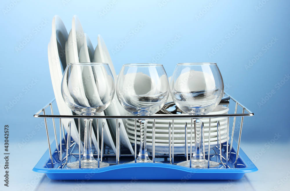 clean dishes on stand on blue background