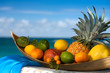 Tropical fruit basket , sea  on the background
