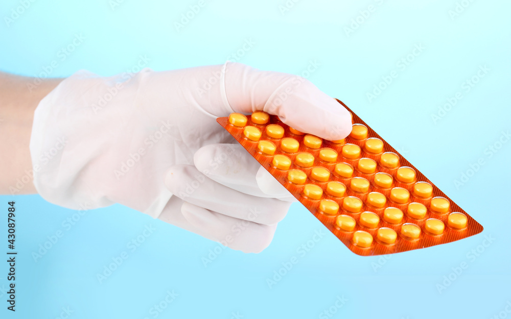 Tablets in hand on blue background