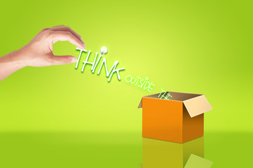 Hand holding think out side the box text for concept idea