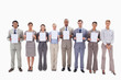 © WavebreakmediaMicro - Business people holding seven supports for letters